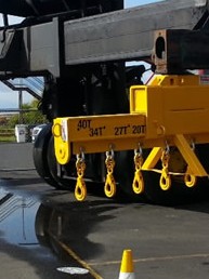 These lifting spreaders were  modified for Patrick Stevedoring. The customer required these modifications so they could  stack 10 to 11 pipes at one time. They were  ESSO oil pipes with special coating that could not be damaged. This lifting spreader can lift up to 45 tonne with an extendable arm.  